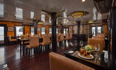 Elegant cruise dining room with panoramic views of Bai Tu Long Bay, perfect for a relaxing Vietnames.