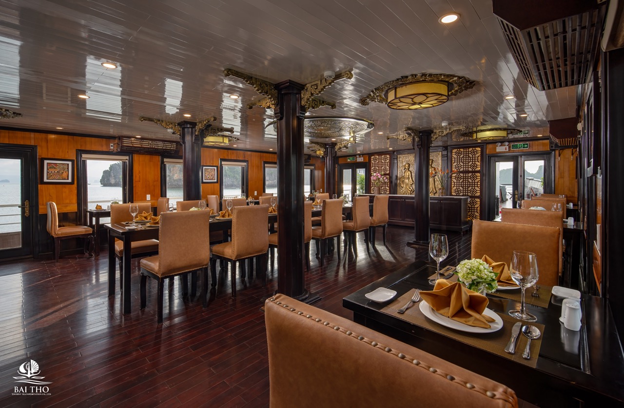 Elegant cruise dining room with panoramic views of Bai Tu Long Bay, perfect for a relaxing Vietnames.