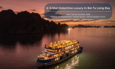Luxurious cruise sailing through Bai Tu Long Bay at sunset, showcasing stunning natural beauty and s.