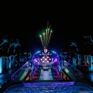 Vietnampool party with fireworks and vibrant lights at night.