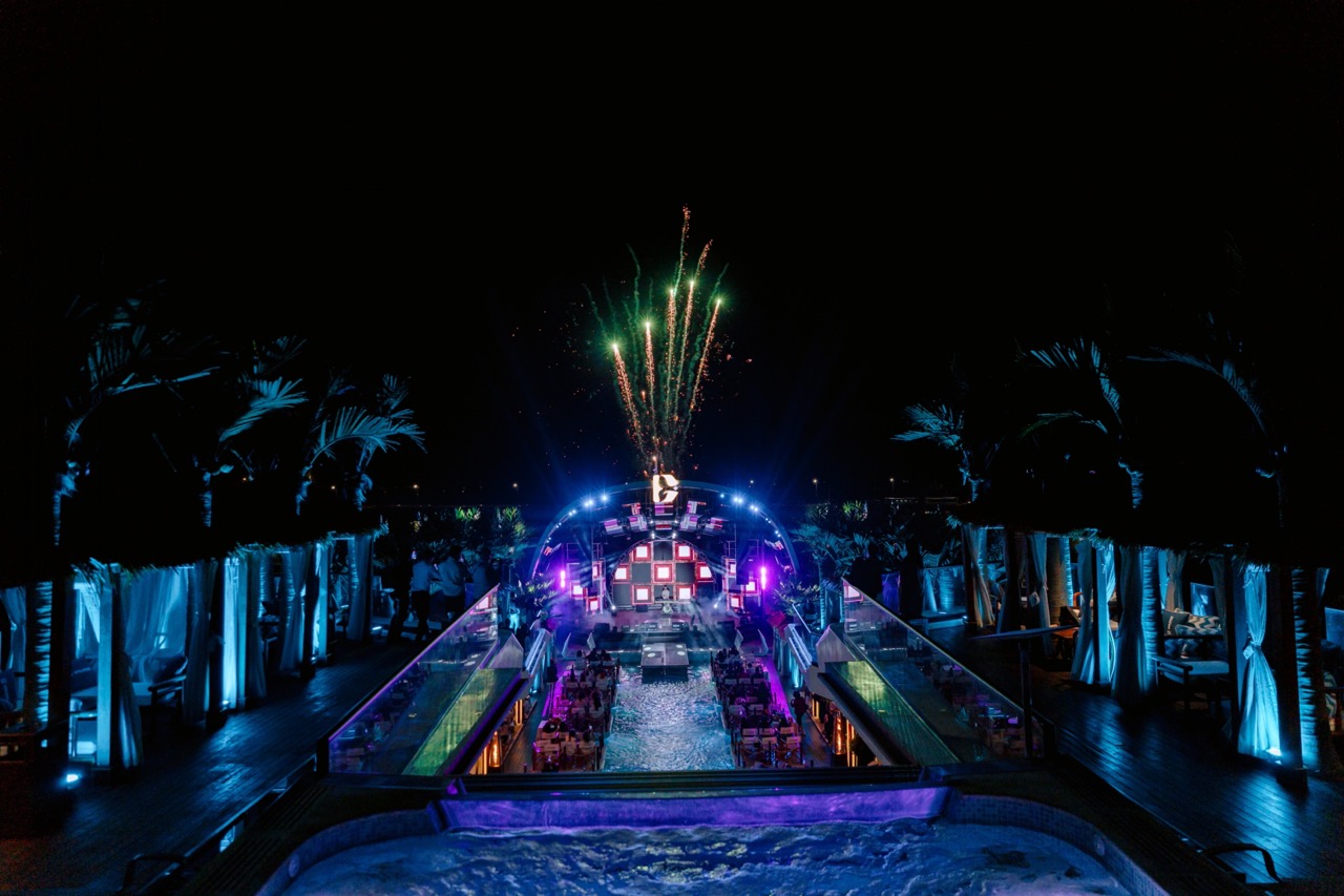 Vietnampool party with fireworks and vibrant lights at night.