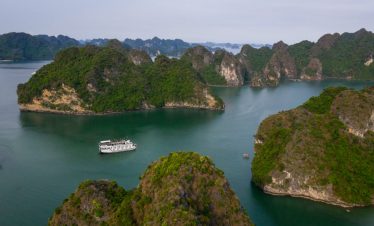 Stunning Halong Bay landscape with limestone karsts and a cruise ship, perfect for exploring scenic.