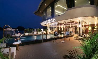 Luxury Halong Bay cruise balcony at night with illuminated deck and modern design, perfect for relax.