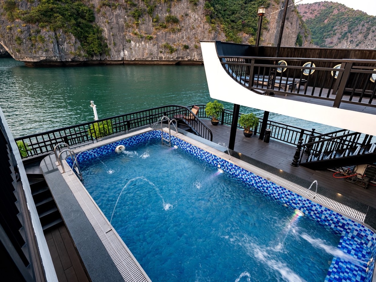 Luxury Halong Bay cruise balcony with private pool, stunning views, and relaxing atmosphere.
