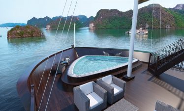 Relaxing cruise balcony with stunning Lan Ha Bay scenery and emerald waters.