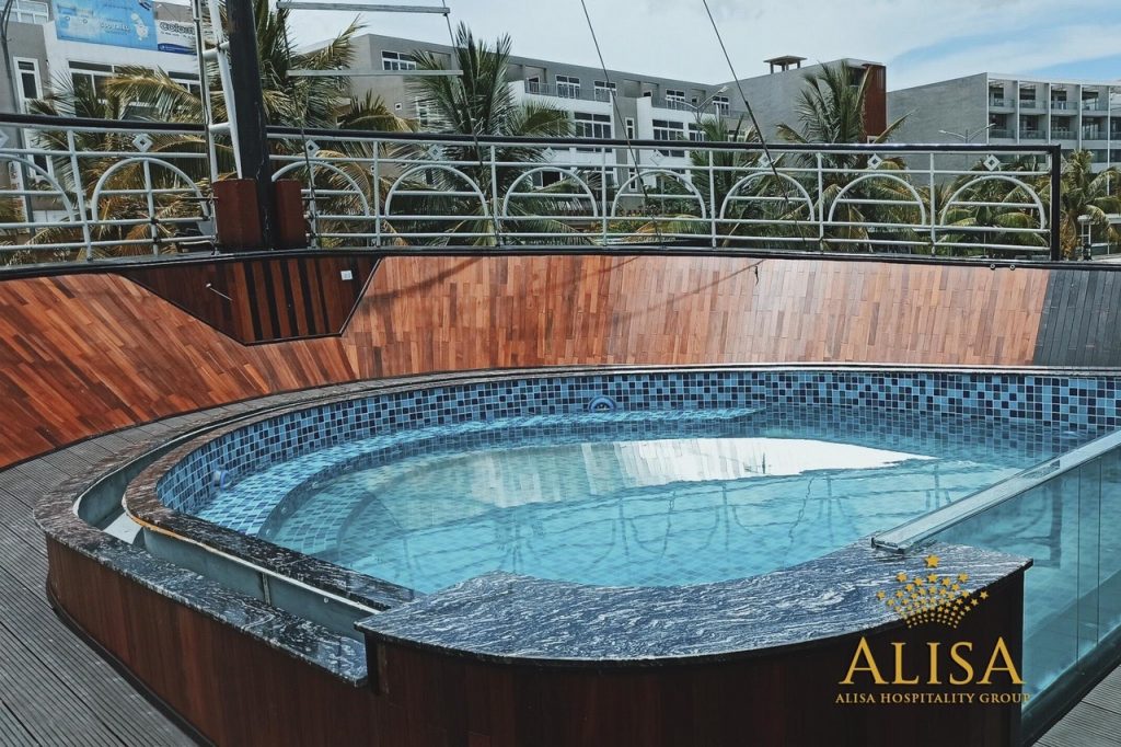 Hot tub on a rooftop with cityscape background, perfect for relaxation during Vietnam travel.