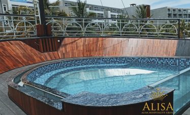 Hot tub on a rooftop with cityscape background, perfect for relaxation during Vietnam travel.