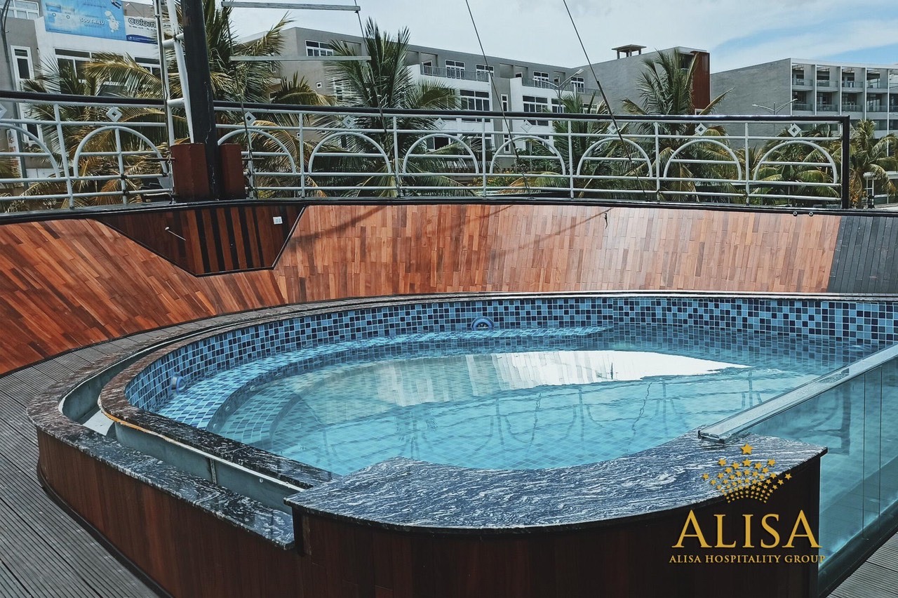 Hot tub on a rooftop with cityscape background, perfect for relaxation during Vietnam travel.