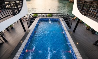 Stunning view of Halong Bay from a cruise balcony with a private pool, perfect for relaxing and enjo.