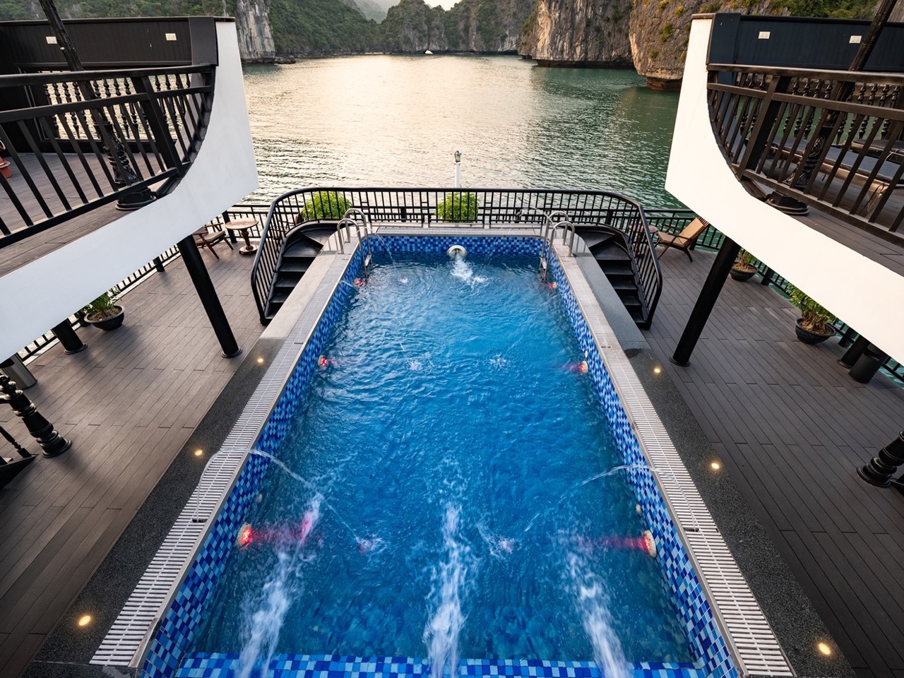 Stunning view of Halong Bay from a cruise balcony with a private pool, perfect for relaxing and enjo.