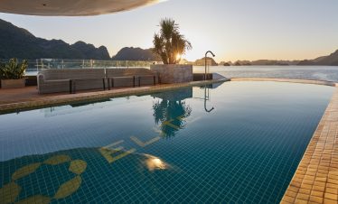 Stunning infinity pool overlooking Halong Bay with scenic mountain backdrop at Elite Of The Seas.