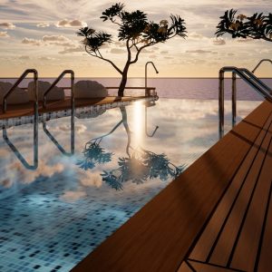 Luxurious infinity pool overlooking ocean at sunset.