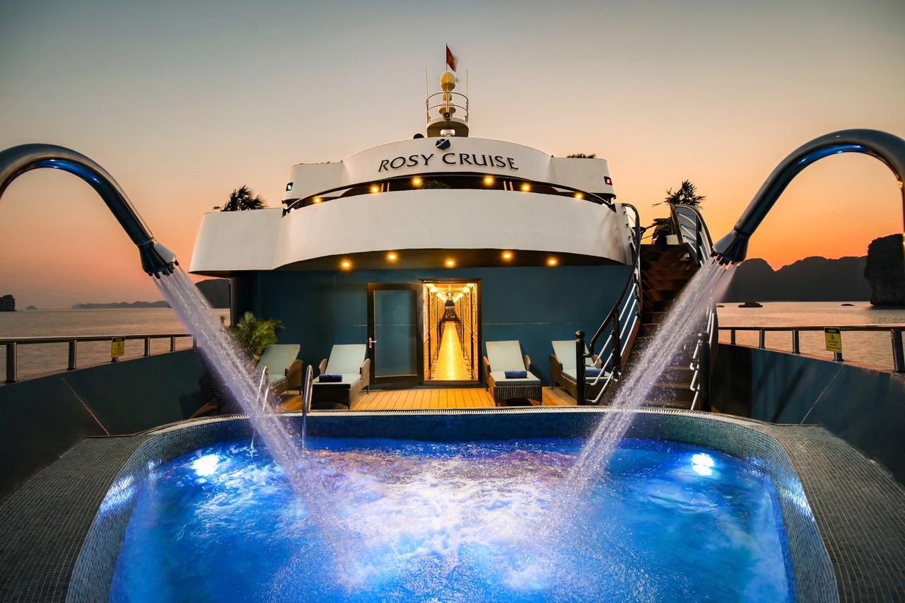 Luxury cruise balcony view in Halong Bay at sunset, perfect for relaxing and sightseeing.