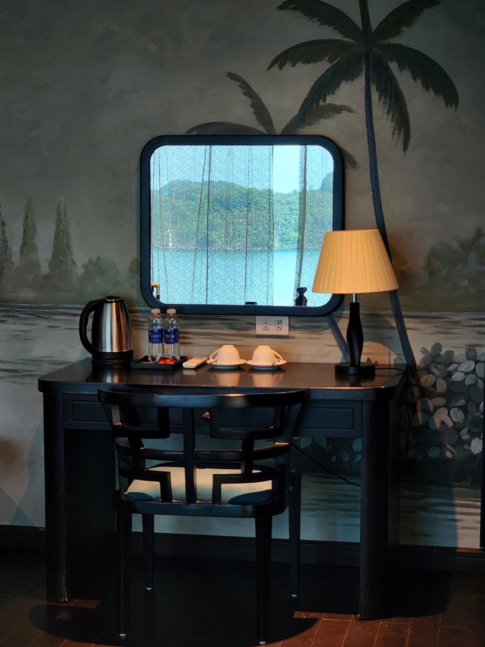 Relaxing view of Halong Bay from cruise balcony with scenic water and mountain landscape.
