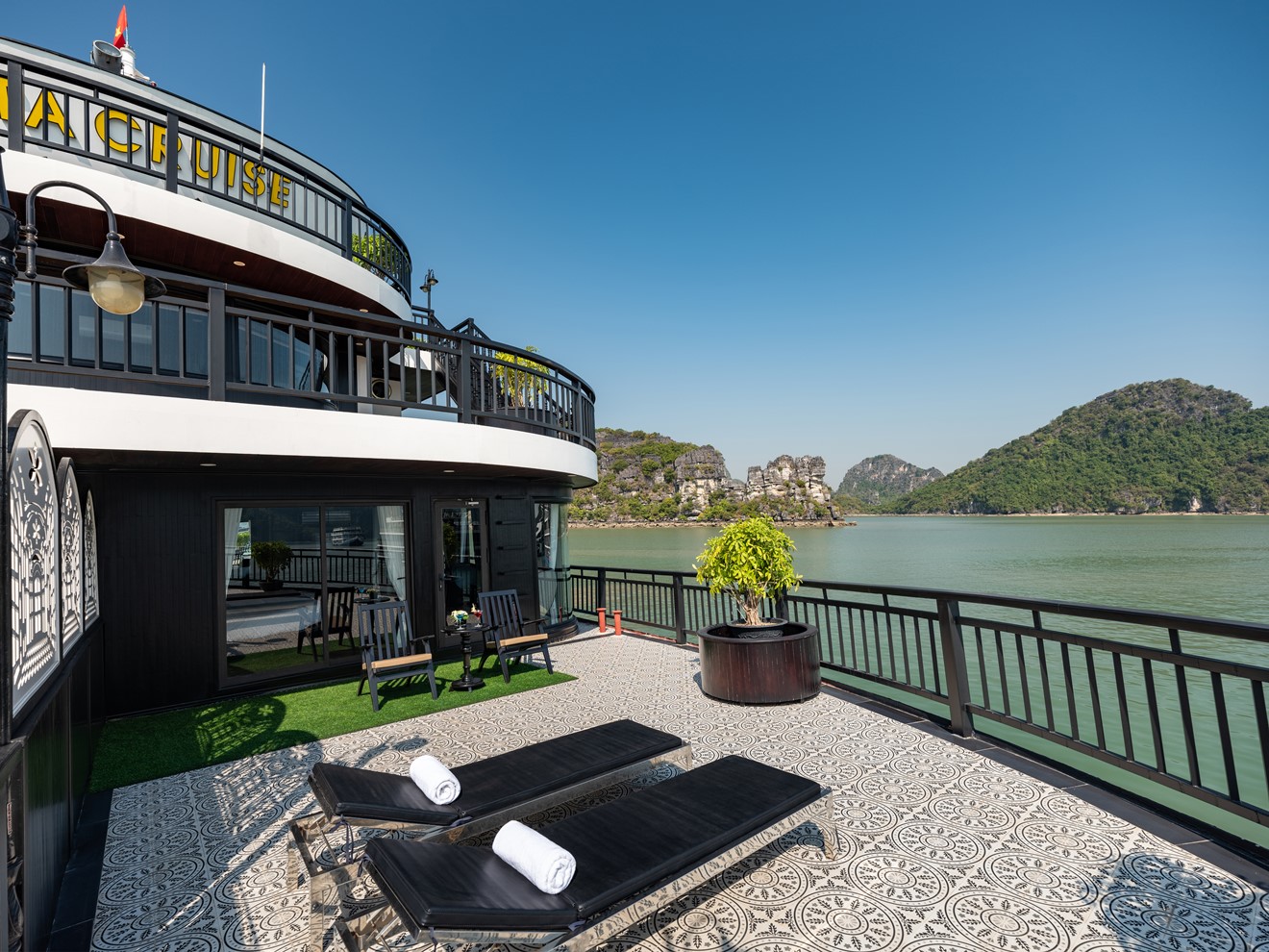Stunning view from a luxury cruise balcony in Halong Bay, with calm waters and lush islands, perfect.