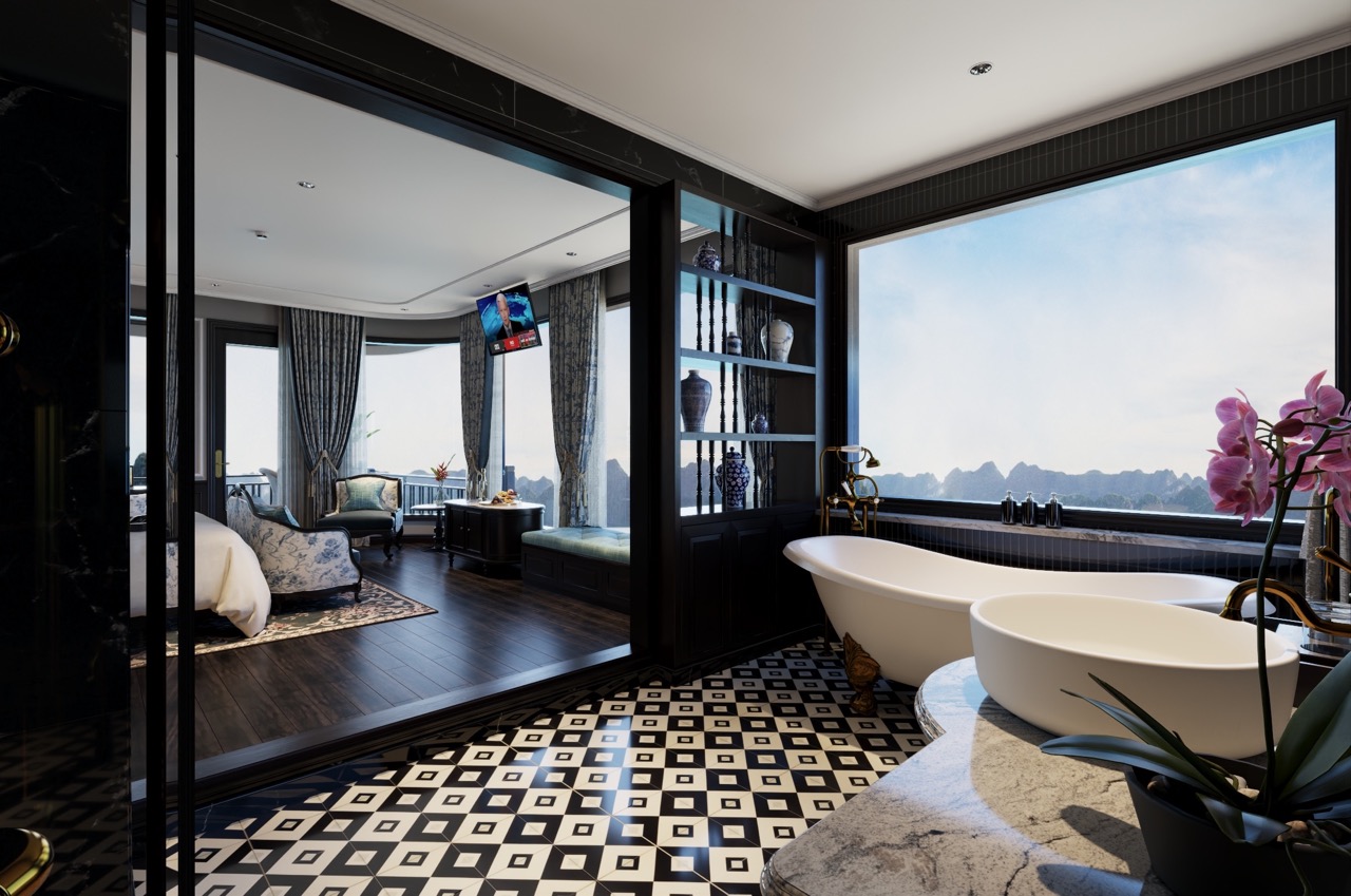 Luxury cruise balcony view in Lan Ha Bay with modern bathtub and scenic mountain backdrop.