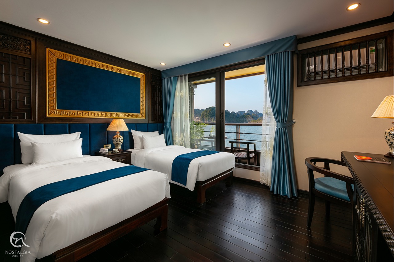 Luxury cruise balcony view of Halong Bay with stunning karst formations and tranquil waters.