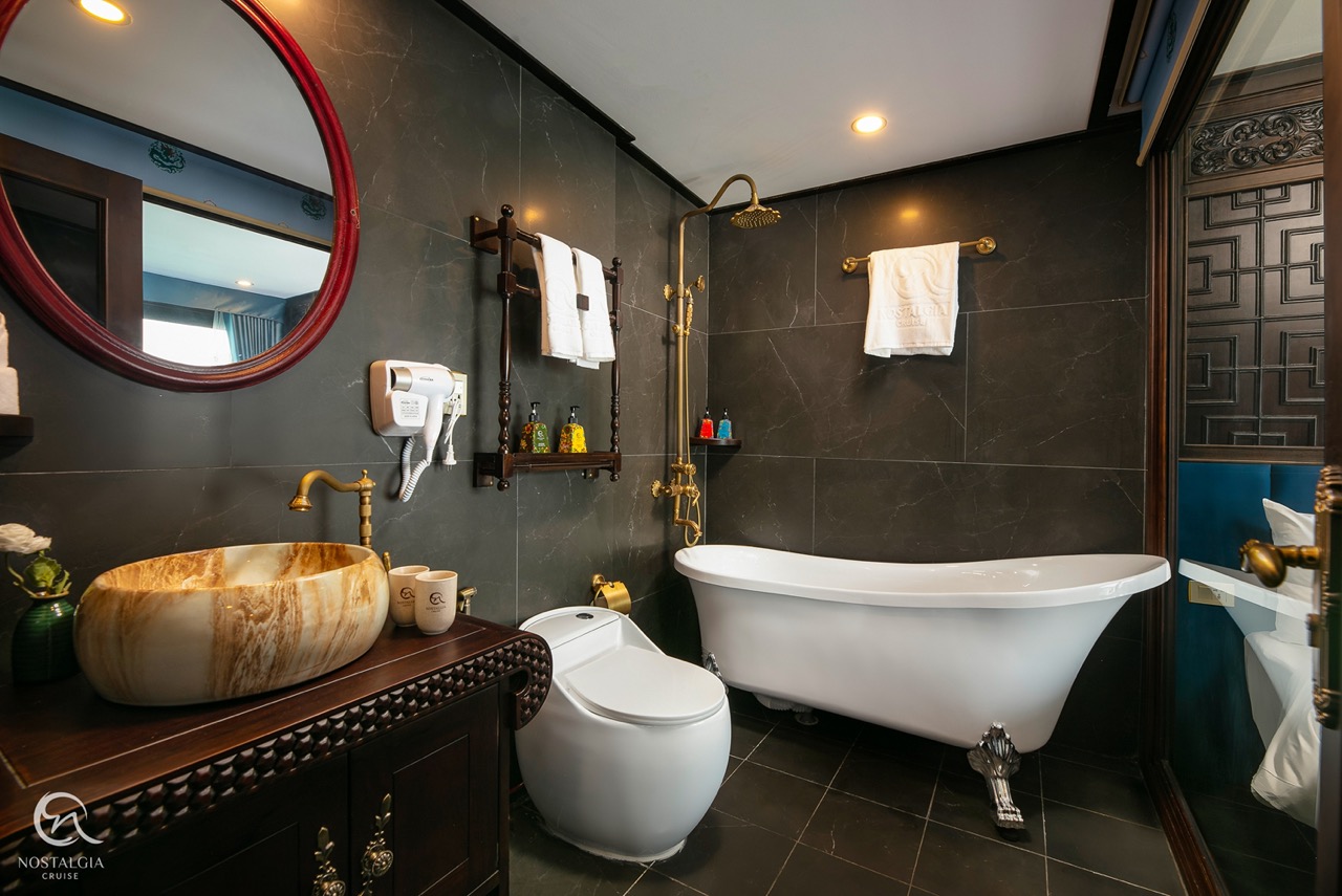 Luxurious bathroom with bathtub and modern amenities on Halong Bay cruise, perfect for a relaxing tr.