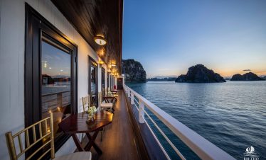 Scenic bay view from cruise balcony in Bai Tu Long Bay with calm waters and limestone islands.