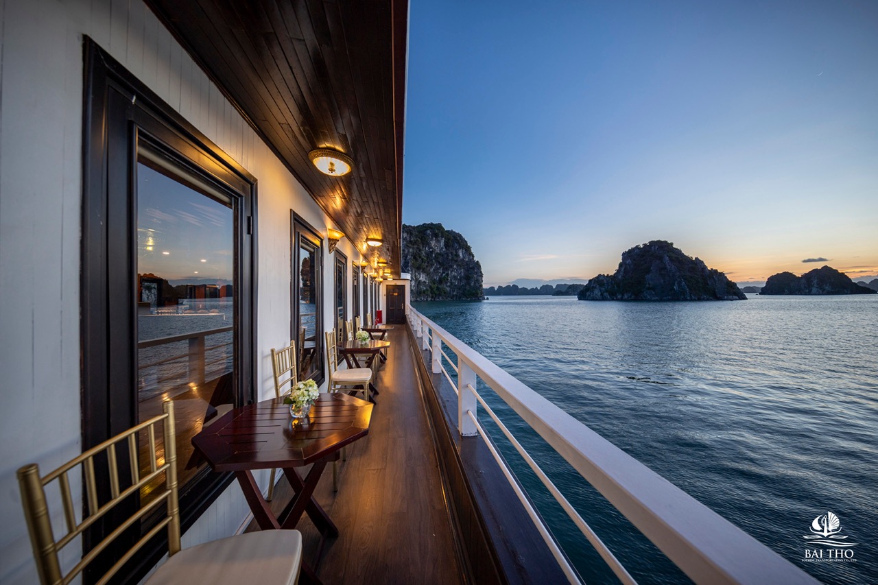 Scenic bay view from cruise balcony in Bai Tu Long Bay with calm waters and limestone islands.