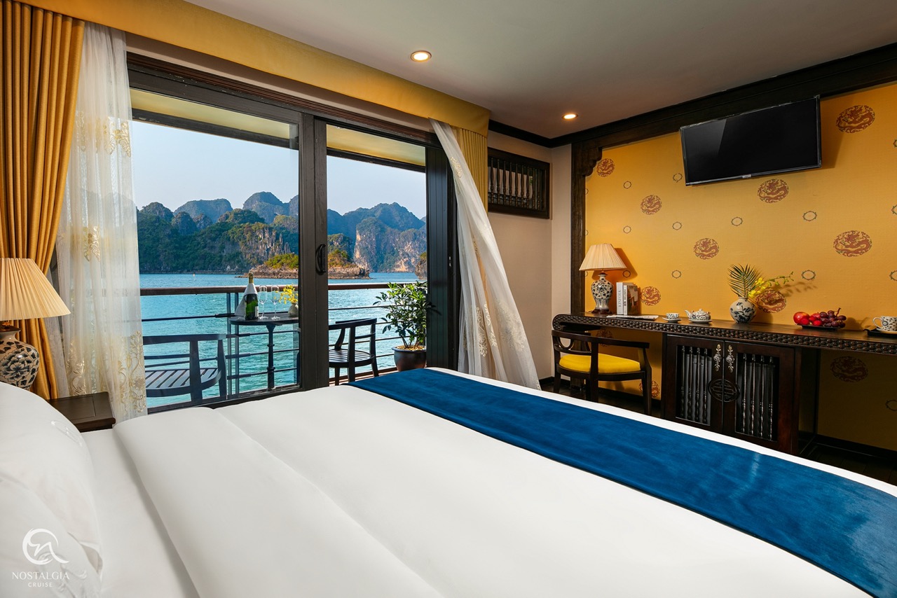 Stunning view from a cruise balcony in Halong Bay, showcasing tranquil waters and limestone islands,.
