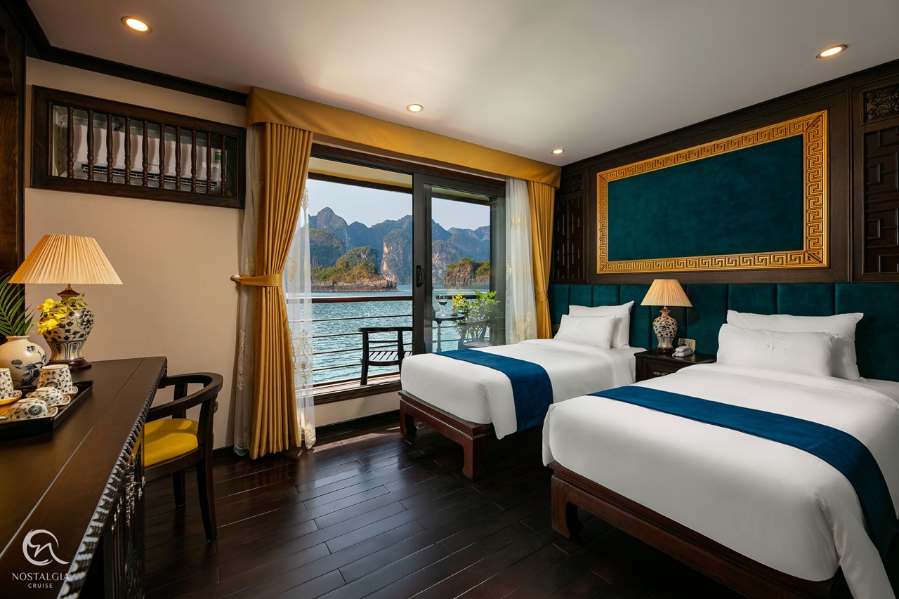 An elegant cruise balcony with stunning views of Halong Bay's limestone karsts and tranquil waters.