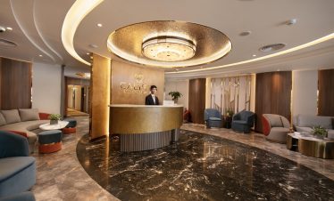 Elegant cruise lobby with modern decor and warm lighting, perfect for relaxing before exploring Halo.