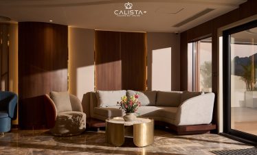 Luxurious cruise lounge with panoramic bay views and elegant seating.