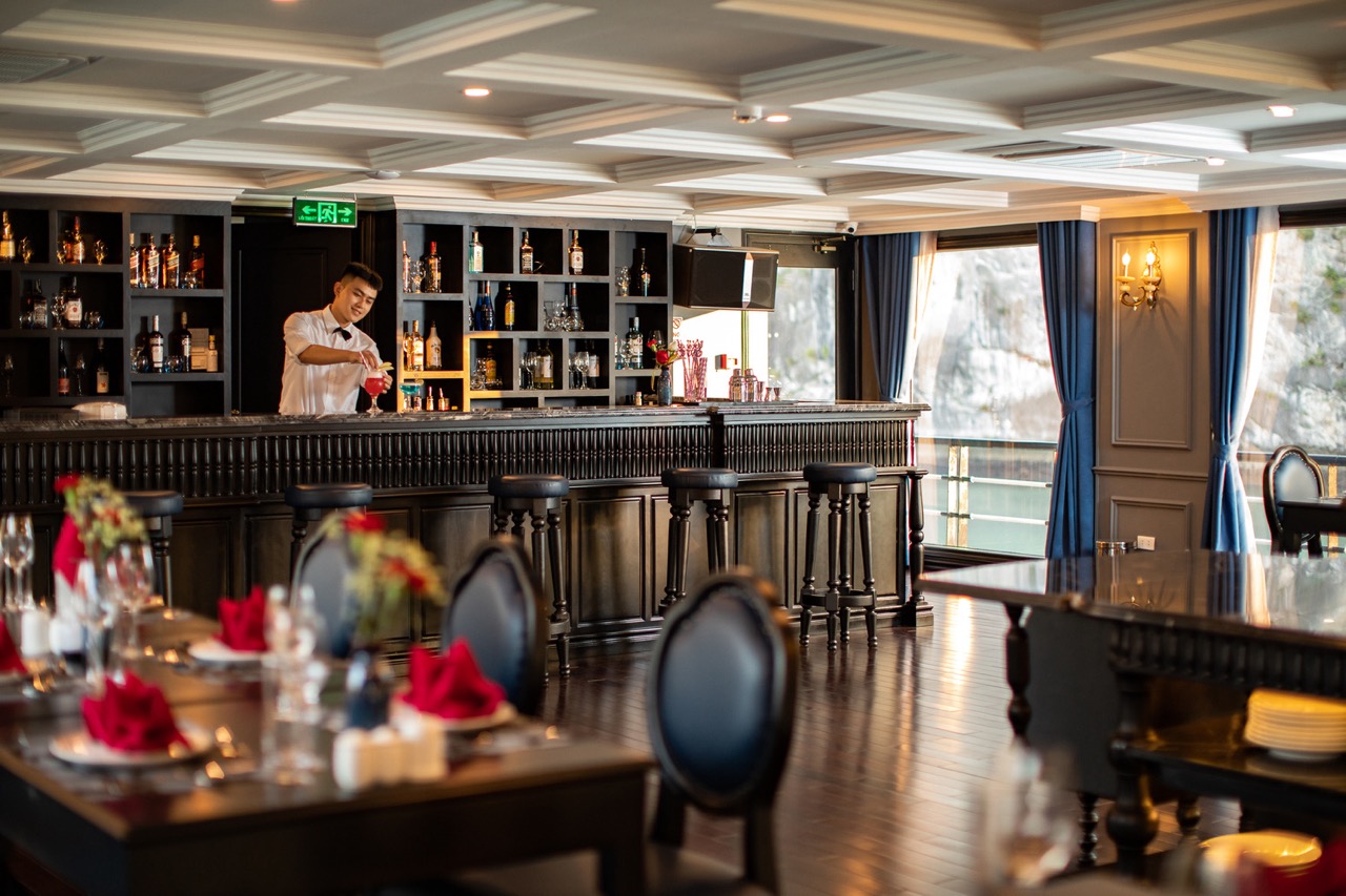 A sophisticated lounge area on a Halong Bay cruise with stylish furnishings and scenic views.
