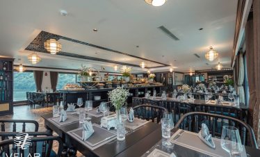 Luxurious cruise dining room with elegant decor and panoramic views, perfect for a memorable Halong.