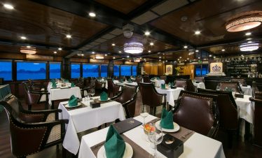 Elegant dining room on Halong Bay cruise with panoramic views and sophisticated ambiance.