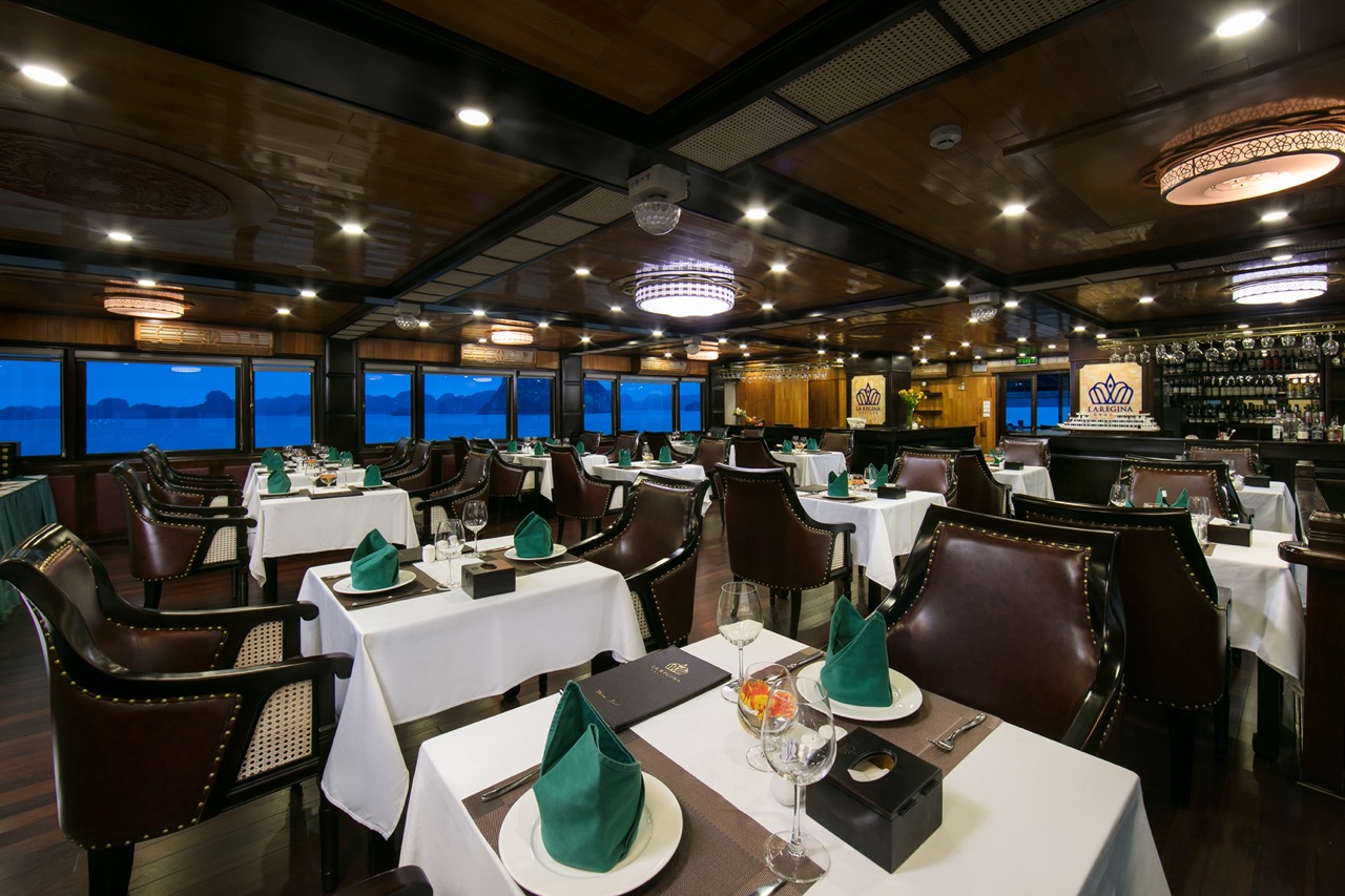 Elegant dining room on Halong Bay cruise with panoramic views and sophisticated ambiance.