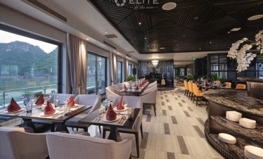 Luxurious Halong Bay cruise balcony with scenic views and elegant dining ambiance.