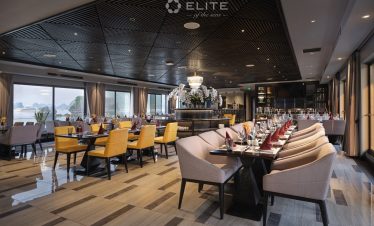 Elegant cruise dining room with panoramic views of Halong Bay, perfect for a romantic and luxurious.