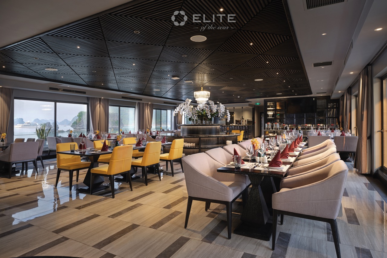 Elegant cruise dining room with panoramic views of Halong Bay, perfect for a romantic and luxurious.