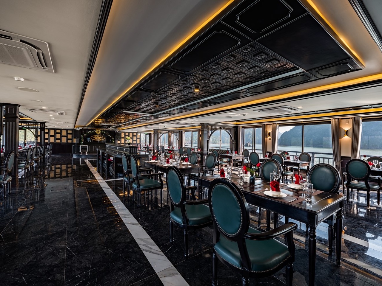 Elegant cruise dining room with panoramic Halong Bay views and sophisticated decor.