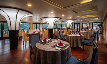 Elegant cruise dining room with luxurious decor and panoramic views of Halong Bay, perfect for a mem.