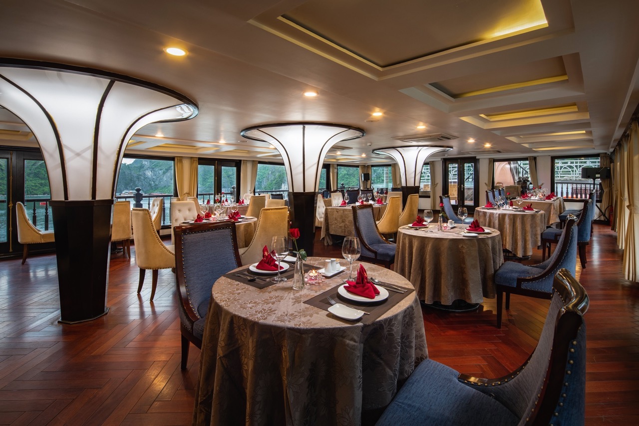 Elegant cruise dining room with luxurious decor and panoramic views of Halong Bay, perfect for a mem.