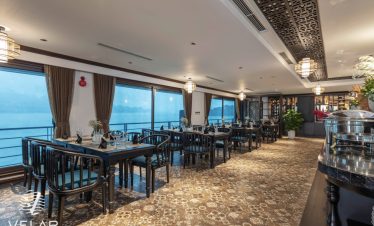Luxurious cruise dining room with panoramic ocean views in Halong Bay, perfect for relaxing and enjo.
