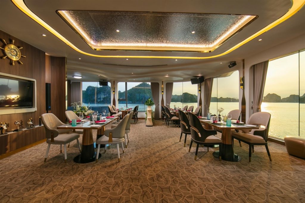 Luxurious cruise lounge with panoramic views of Halong Bay, elegant decor, and comfortable seating f.