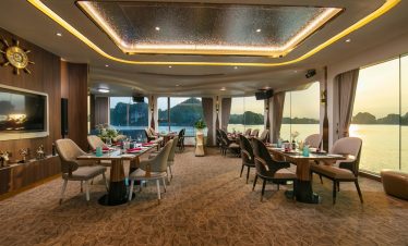Luxurious cruise lounge with panoramic views of Halong Bay, elegant decor, and comfortable seating f.