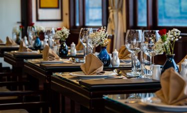 Luxurious cruise dining scene with beautifully arranged table settings and floral decor, perfect for.