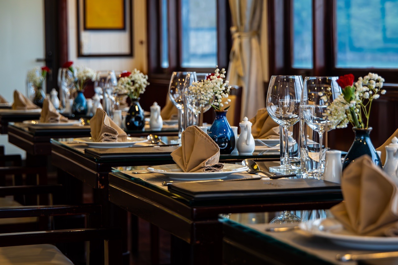 Luxurious cruise dining scene with beautifully arranged table settings and floral decor, perfect for.