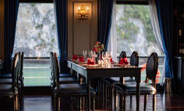 Elegant dining area on Halong Bay cruise with scenic water views and luxurious ambiance.
