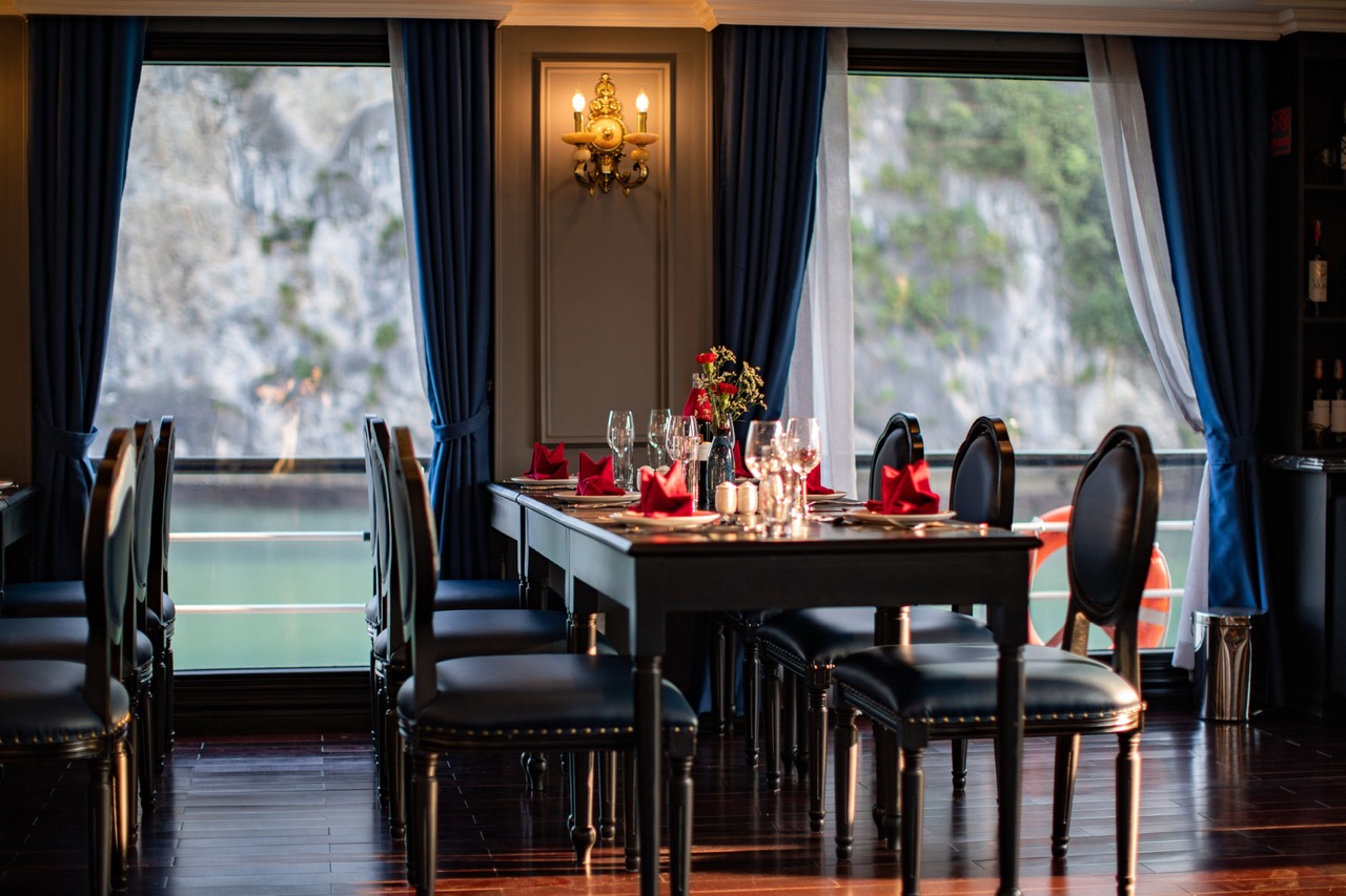 Elegant dining area on Halong Bay cruise with scenic water views and luxurious ambiance.