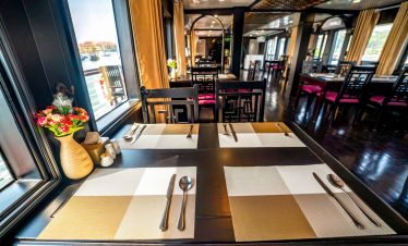 Luxurious cruise dining room with scenic views of Halong Bay, ideal for a 2-day cruise adventure.