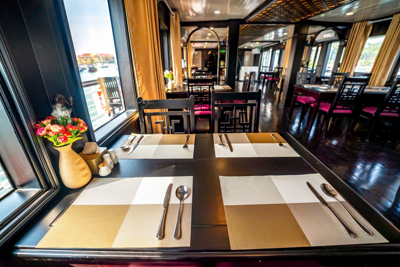 Luxurious cruise dining room with scenic views of Halong Bay, ideal for a 2-day cruise adventure.