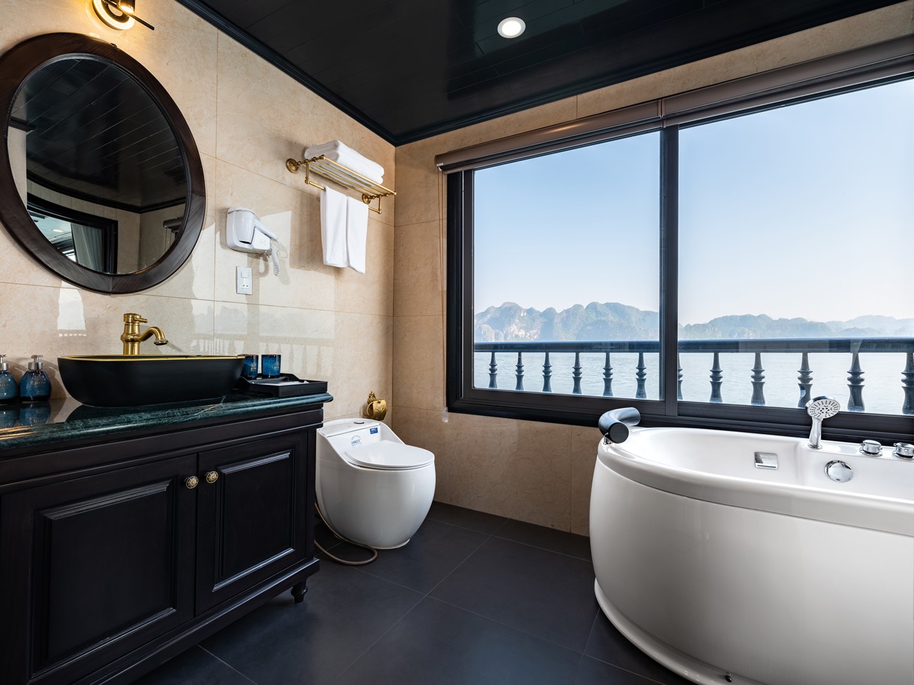Luxurious bathroom with panoramic bay view on Halong Bay cruise.