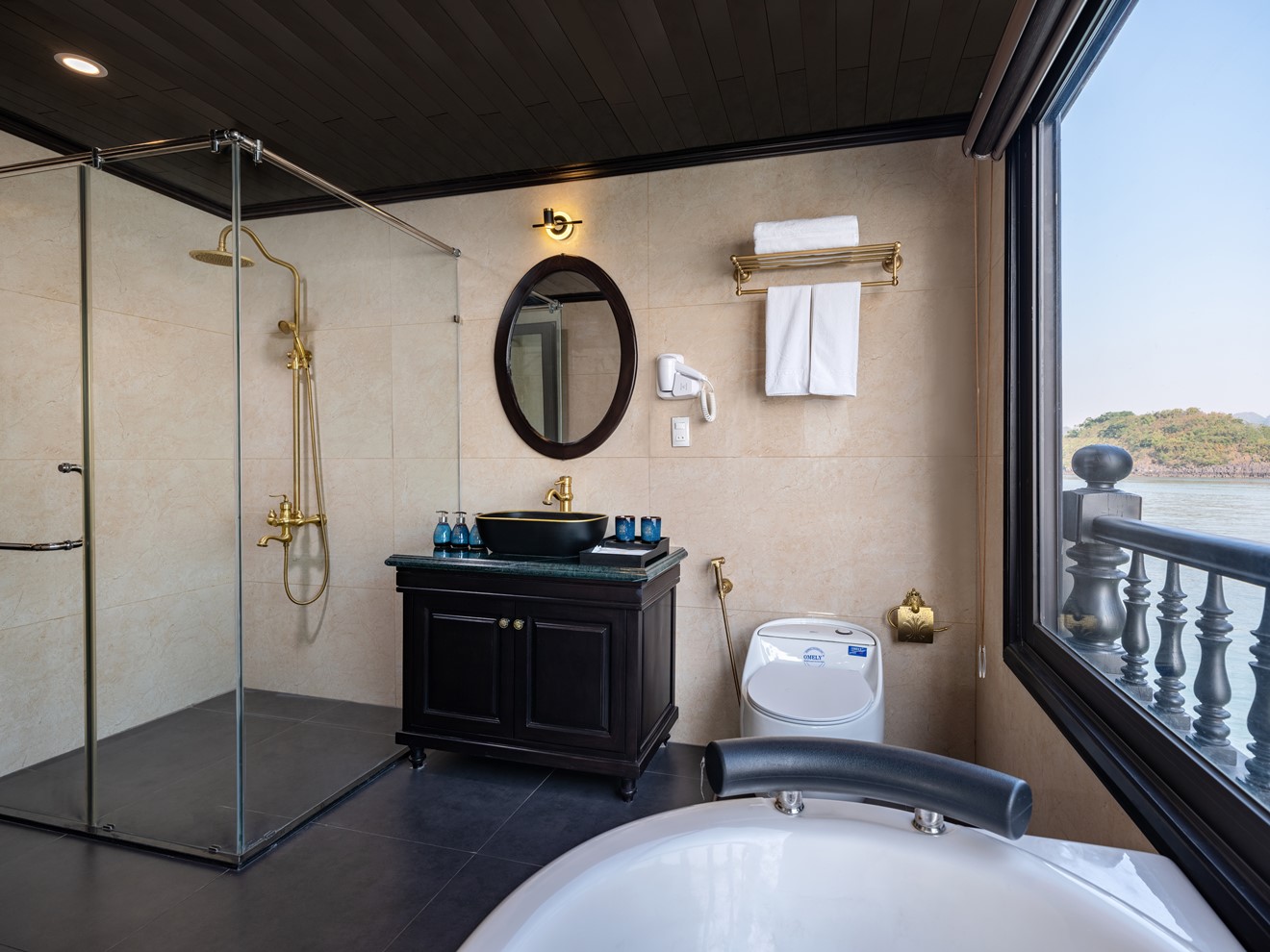 Elegant bathroom with shower and scenic bay view on Halong Bay cruise.