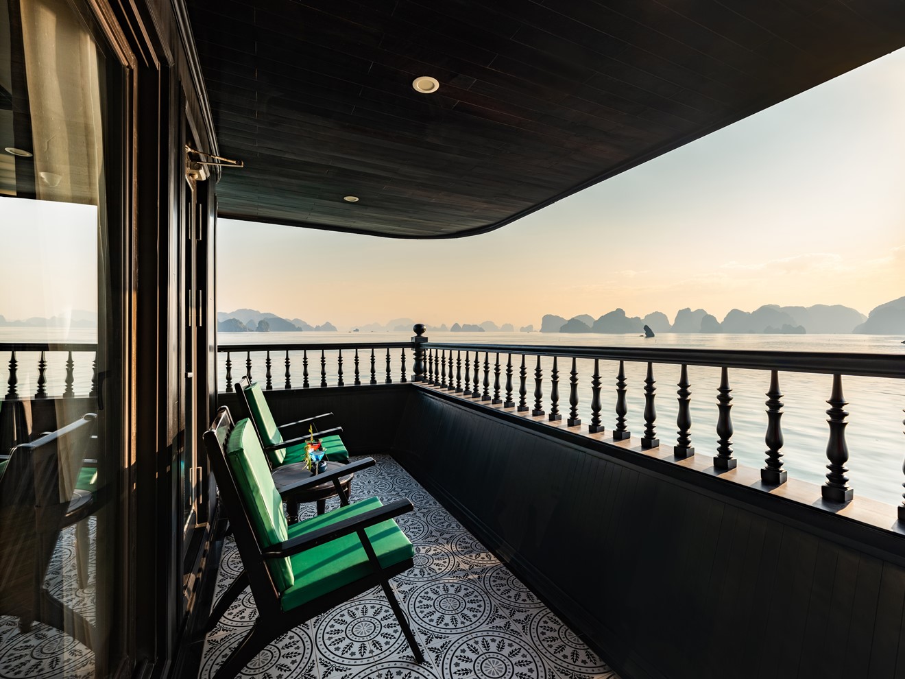 Stunning Halong Bay scenery from a cruise balcony, capturing the tranquil waters and majestic limest.
